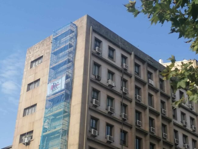 Scaffolding removing fasicst symbols from building in Caceres, Spain.