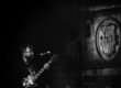 Guitarist in the Old Town of Caceres in front of a medieval shield.